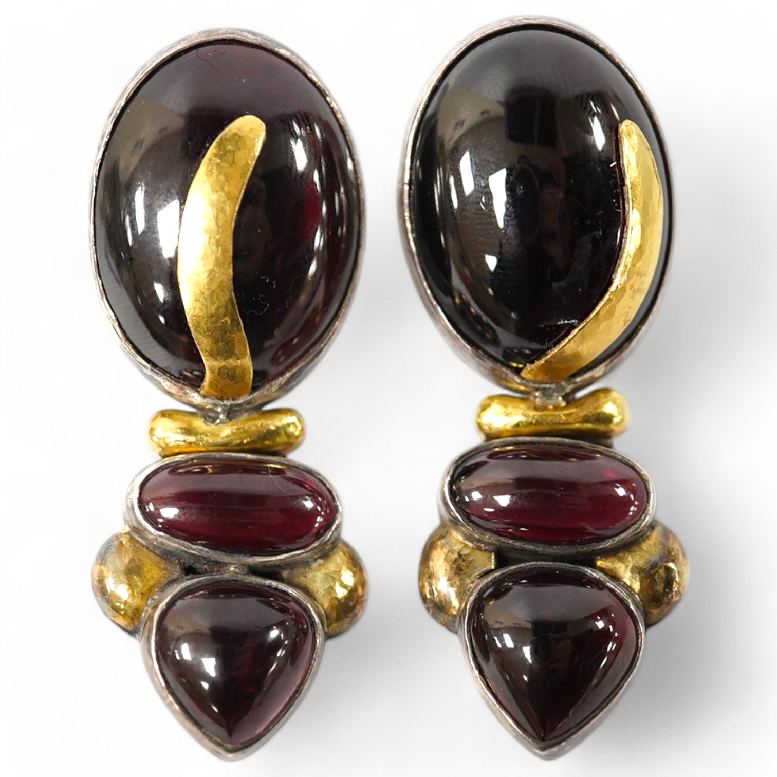 A pair of modern yellow and white metal mounted three stone oval cabochon garnet set drop earrings, by Elaine Coyne, signed, 51mm, gross weight 28.2 grams. Condition - fair